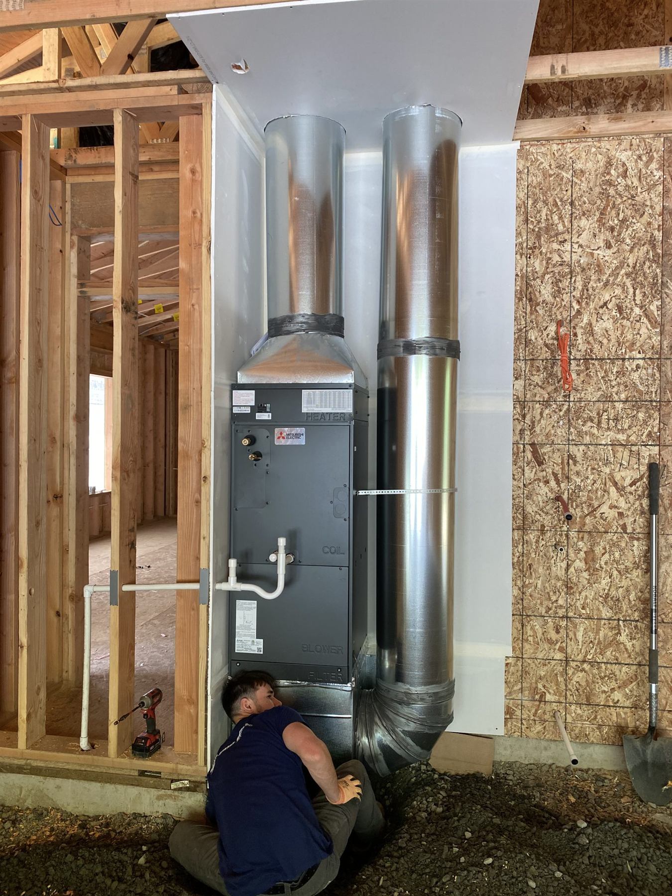 A furnace being installed in a house under construction